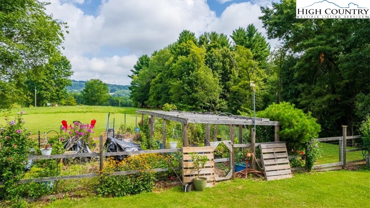 360 Fraser Road Sparta, NC 28675 - Photo 7 of 50 a view of a swimming pool with a patio and a garden