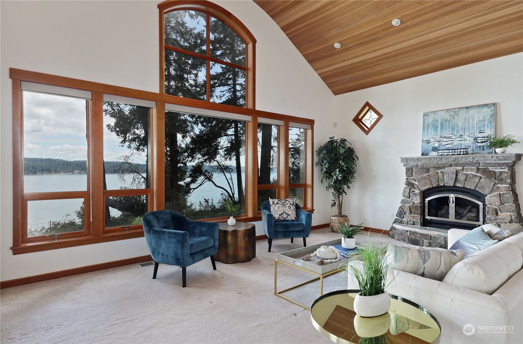 1292 Dines Point Road Greenbank, WA 98253 - Photo 11 of 40 a living room with furniture a fireplace and a large window