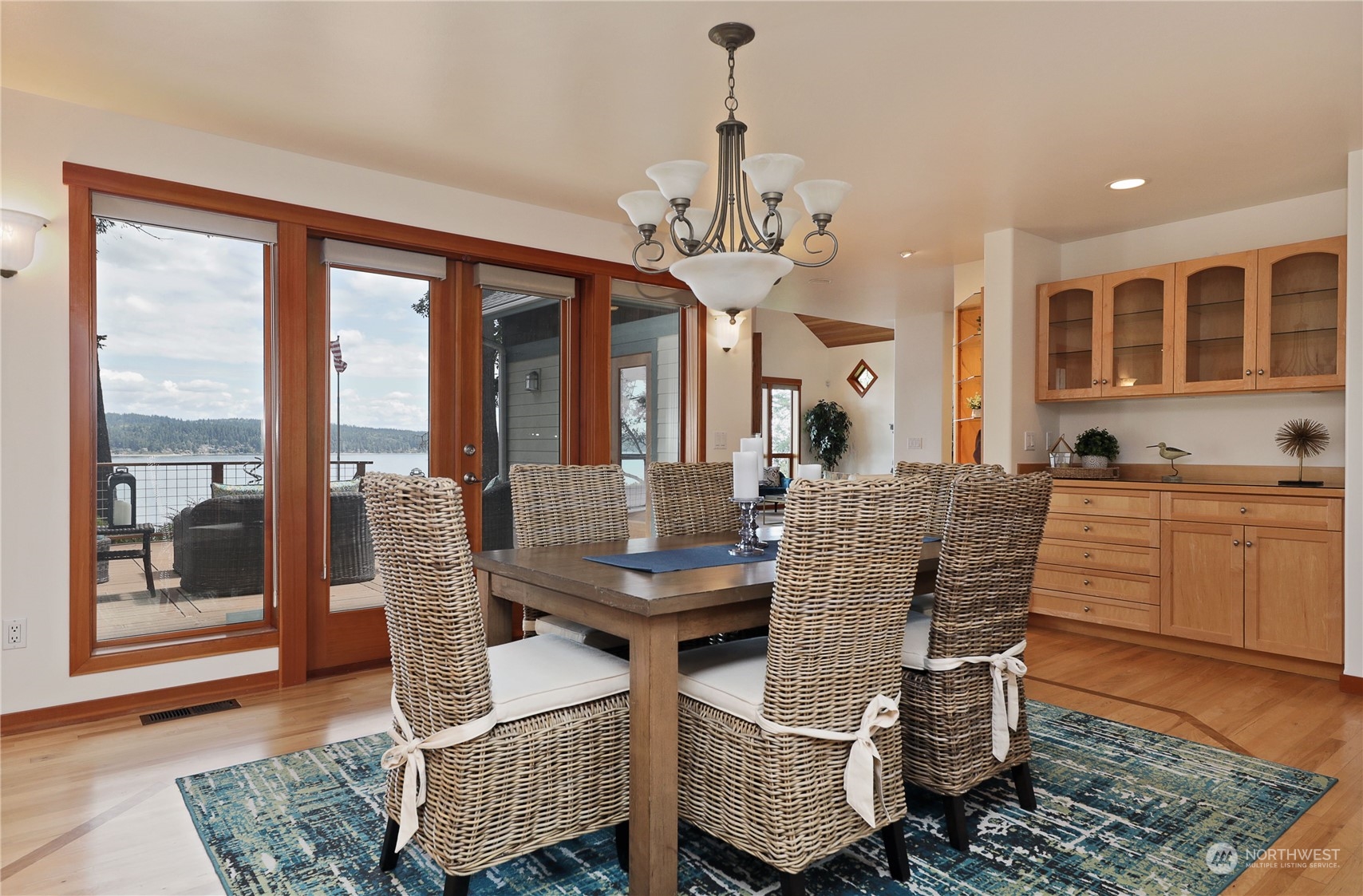 1292 Dines Point Road Greenbank, WA 98253 - Photo 13 of 40 a dining room with furniture a chandelier and wooden floor