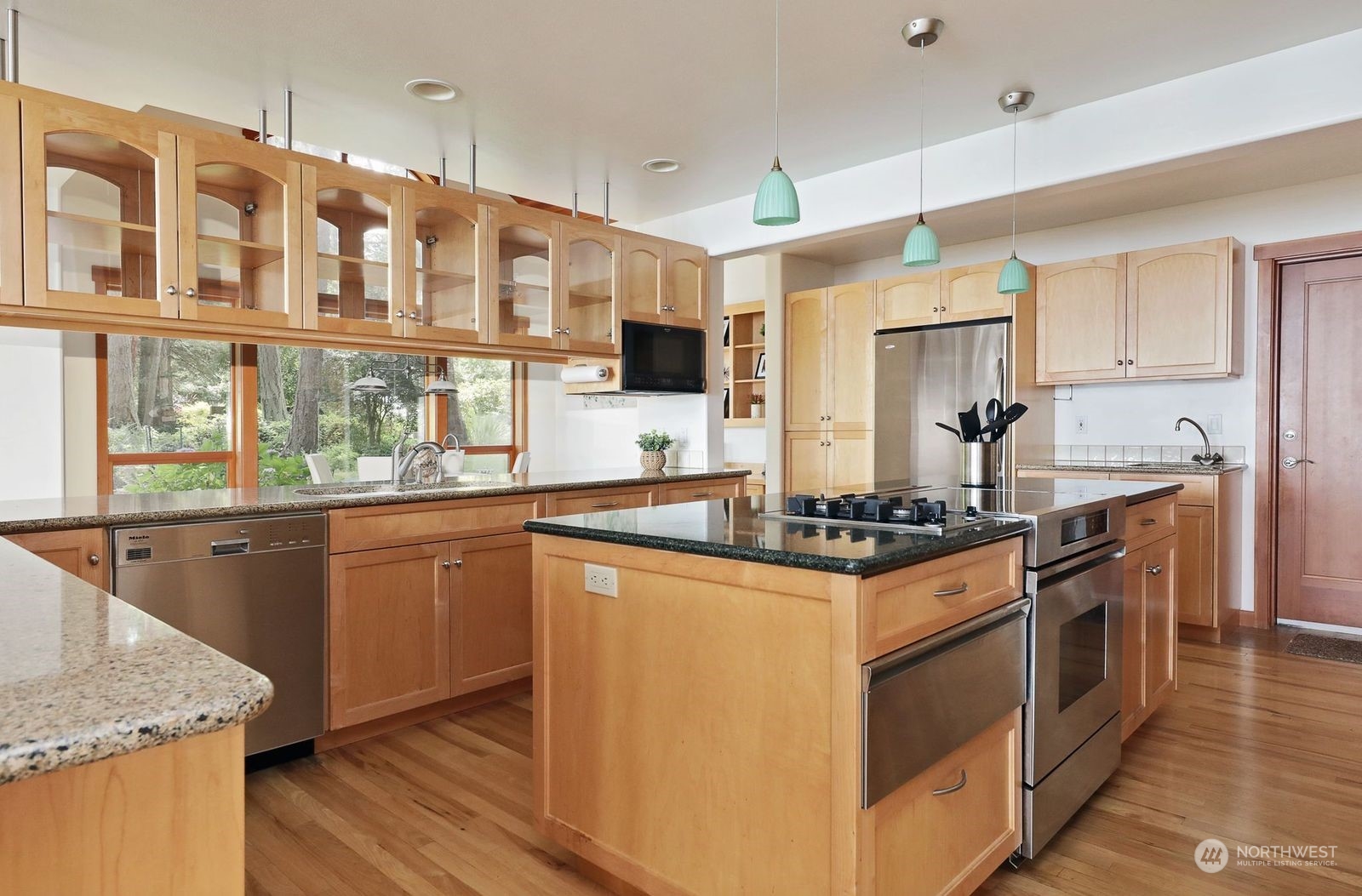 1292 Dines Point Road Greenbank, WA 98253 - Photo 14 of 40 a kitchen with stainless steel appliances granite countertop a stove and a sink