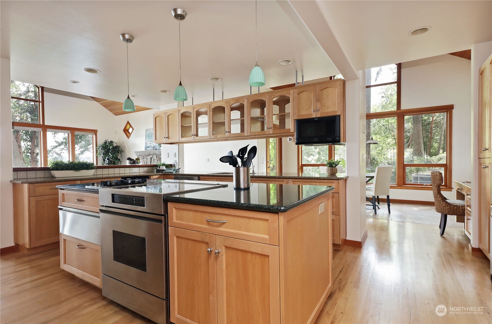 1292 Dines Point Road Greenbank, WA 98253 - Photo 15 of 40 a kitchen with stainless steel appliances granite countertop a stove and a sink