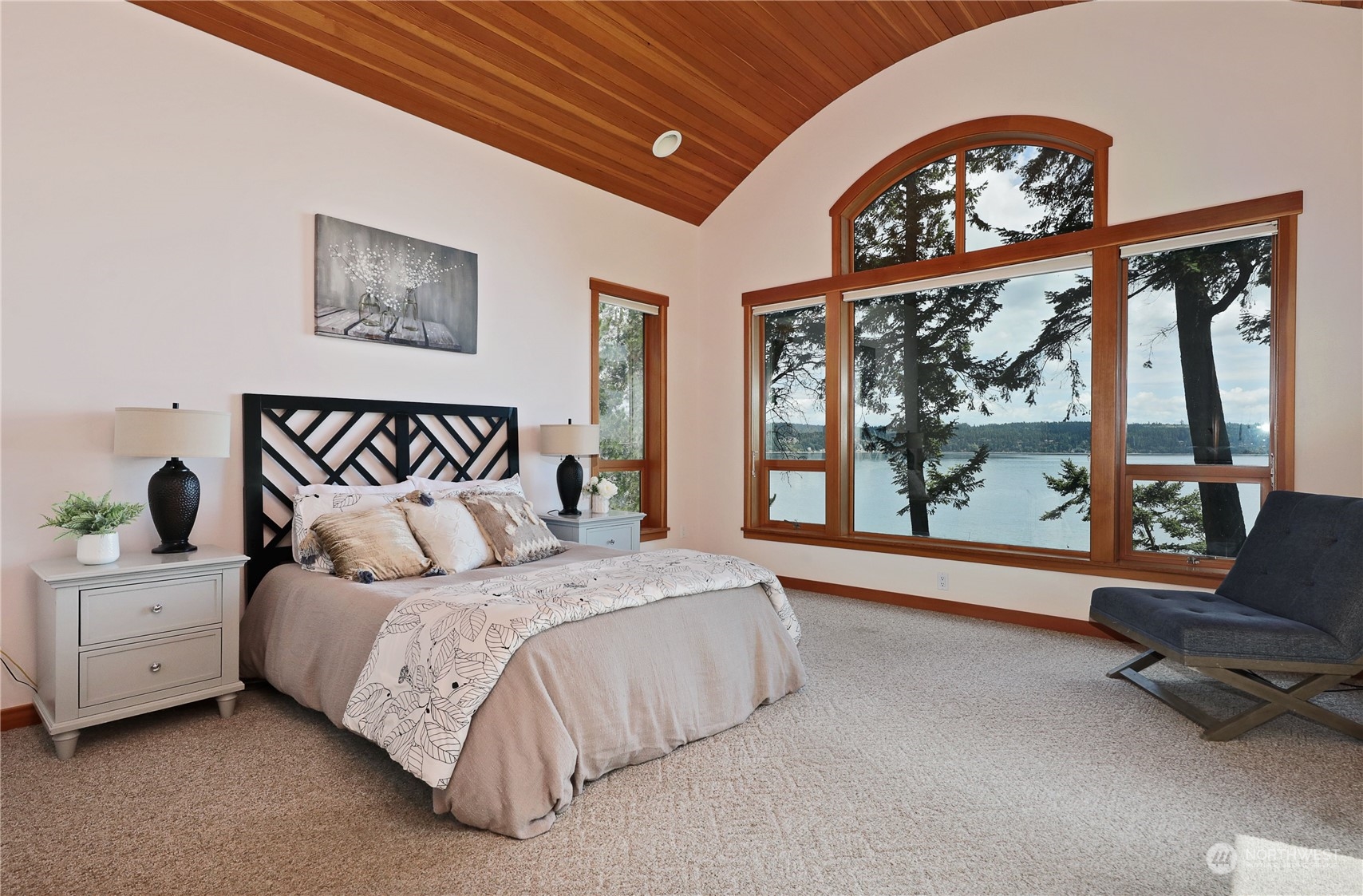 1292 Dines Point Road Greenbank, WA 98253 - Photo 19 of 40 a spacious bedroom with a bed a couch and a large window