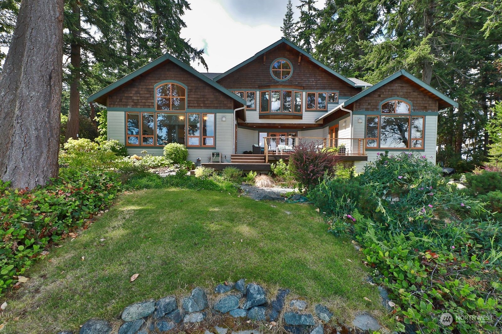1292 Dines Point Road Greenbank, WA 98253 - Photo 2 of 40 a front view of a house with garden
