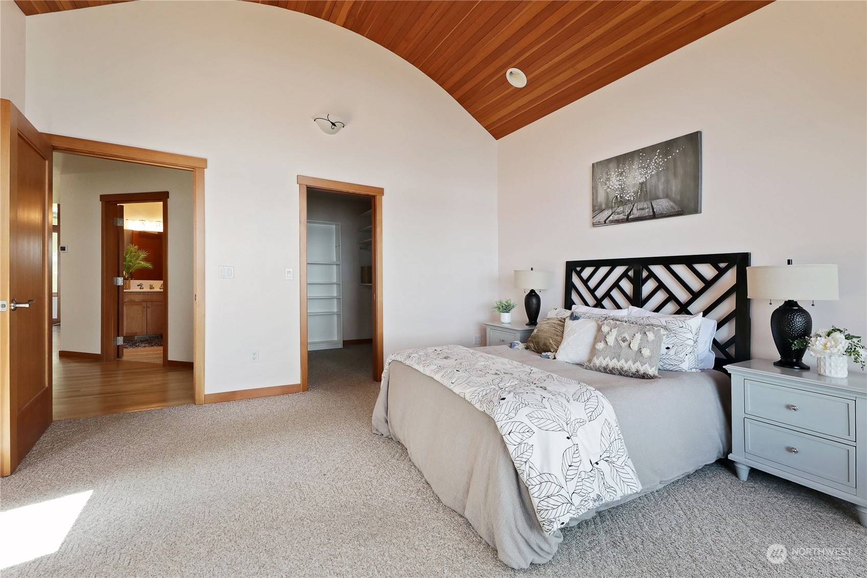 1292 Dines Point Road Greenbank, WA 98253 - Photo 21 of 40 a spacious bedroom with a bed and a lamp