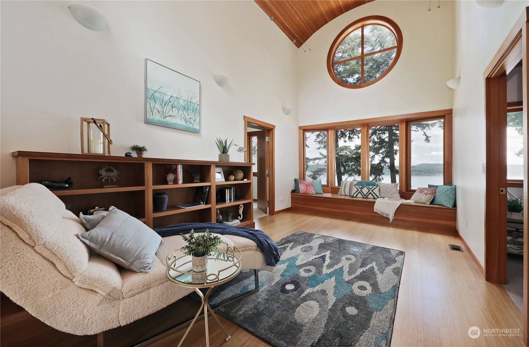 1292 Dines Point Road Greenbank, WA 98253 - Photo 24 of 40 a living room with furniture a rug a clock and a large window