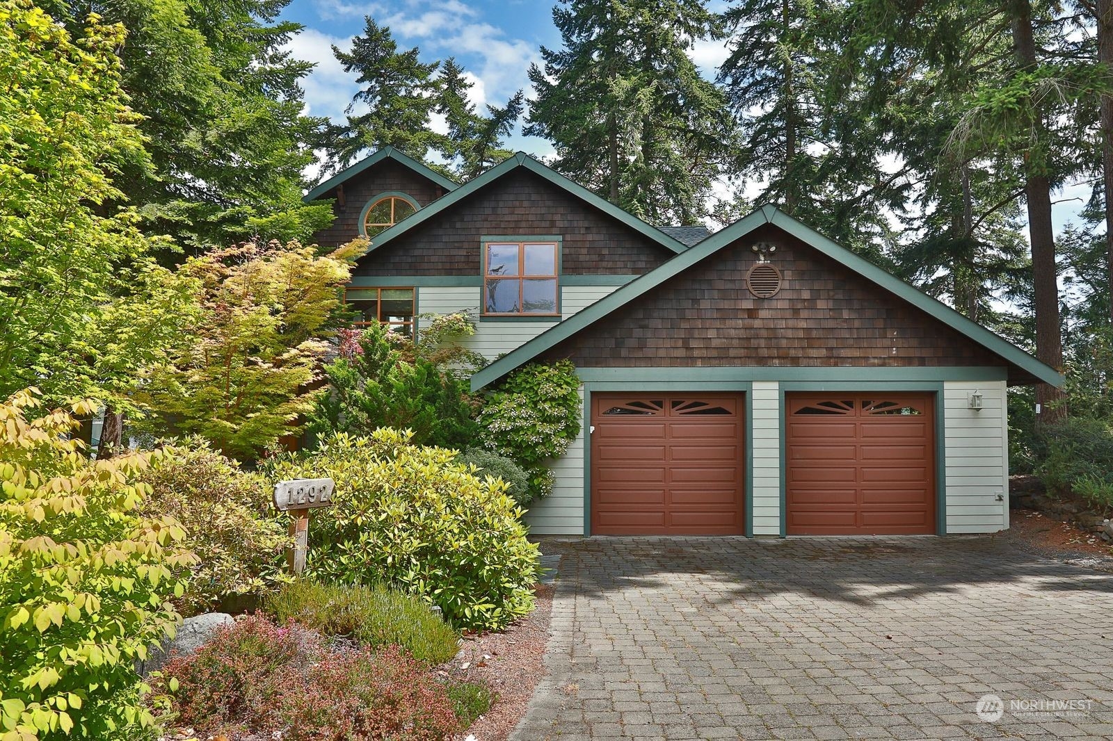 1292 Dines Point Road Greenbank, WA 98253 - Photo 4 of 40 a view of a house with a yard and garage