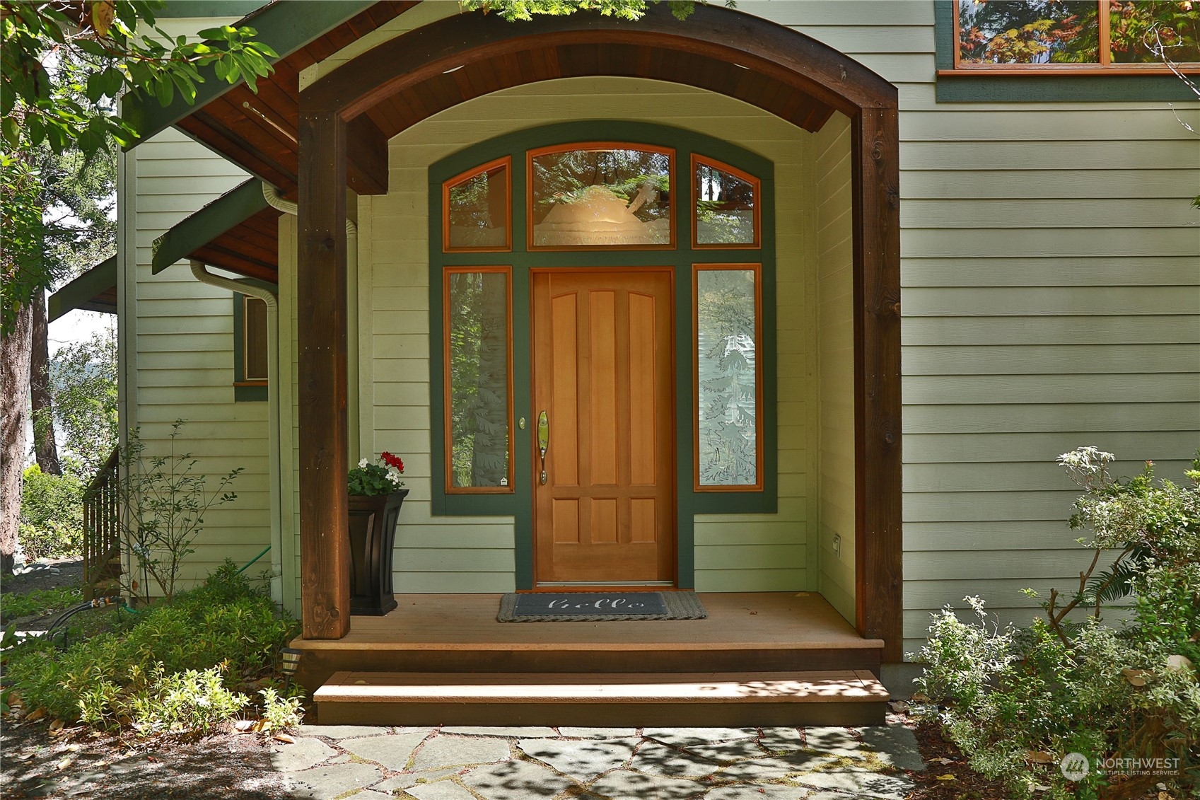 1292 Dines Point Road Greenbank, WA 98253 - Photo 5 of 40 a front view of a house with a garden