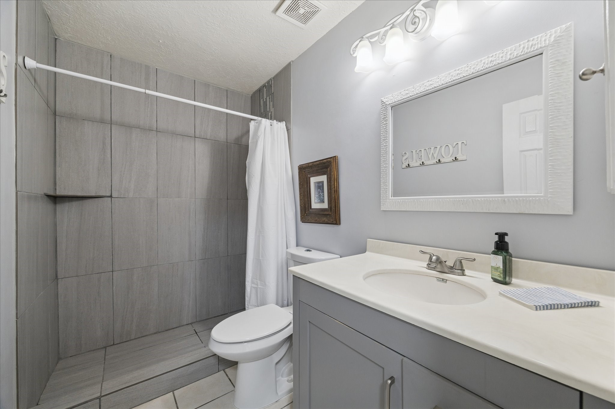 9306 Riverside Lodge Drive Houston, TX 77083 - Photo 18 of 20 a bathroom with a sink toilet and shower