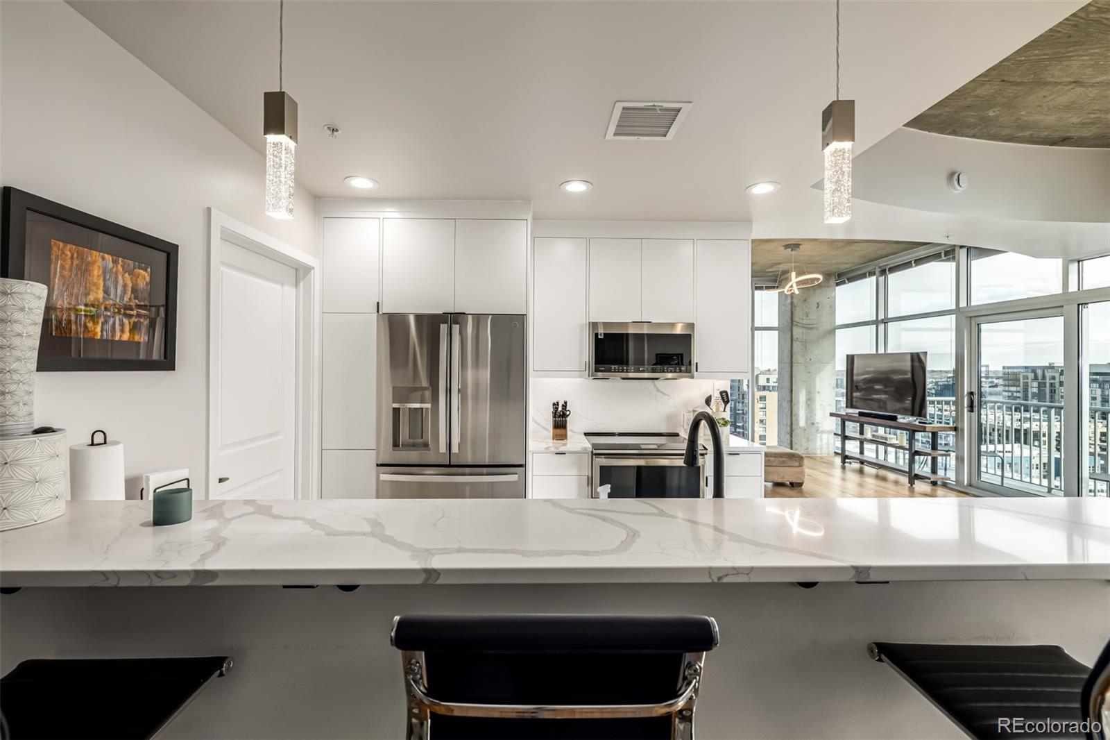 a kitchen with stainless steel appliances a sink and a refrigerator