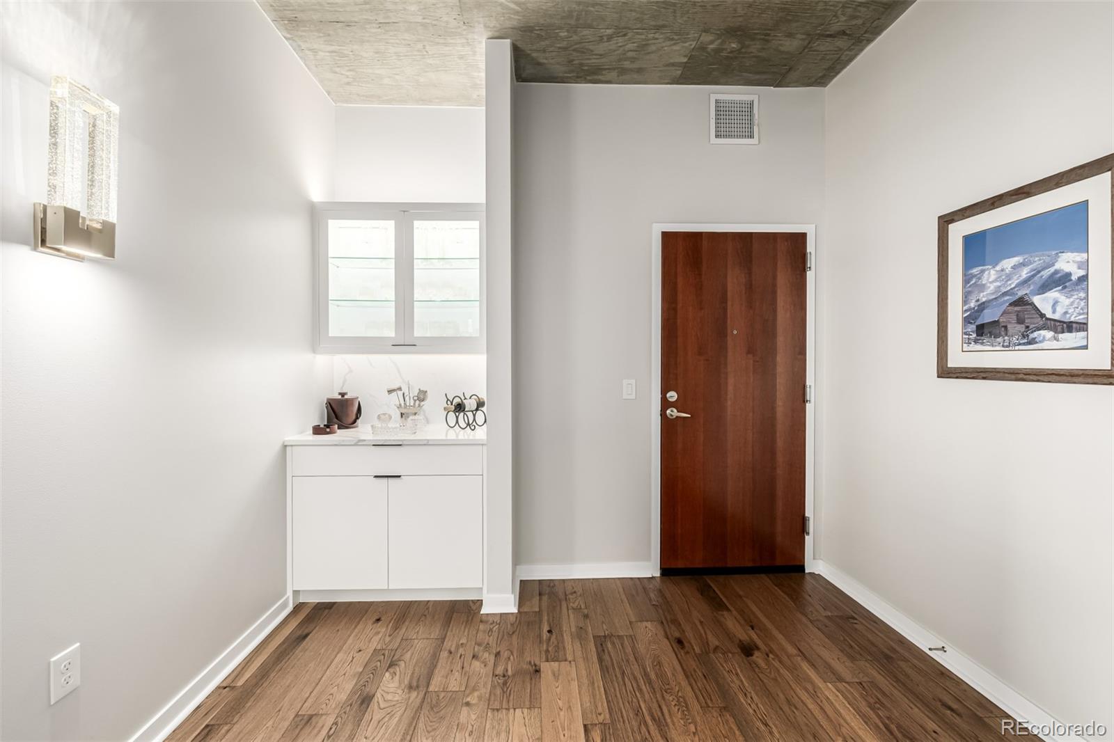 1700 Bassett Street, Unit 1412 Denver, CO 80202 - Photo 16 of 43 a view of a hallway with wooden floor and a bathroom