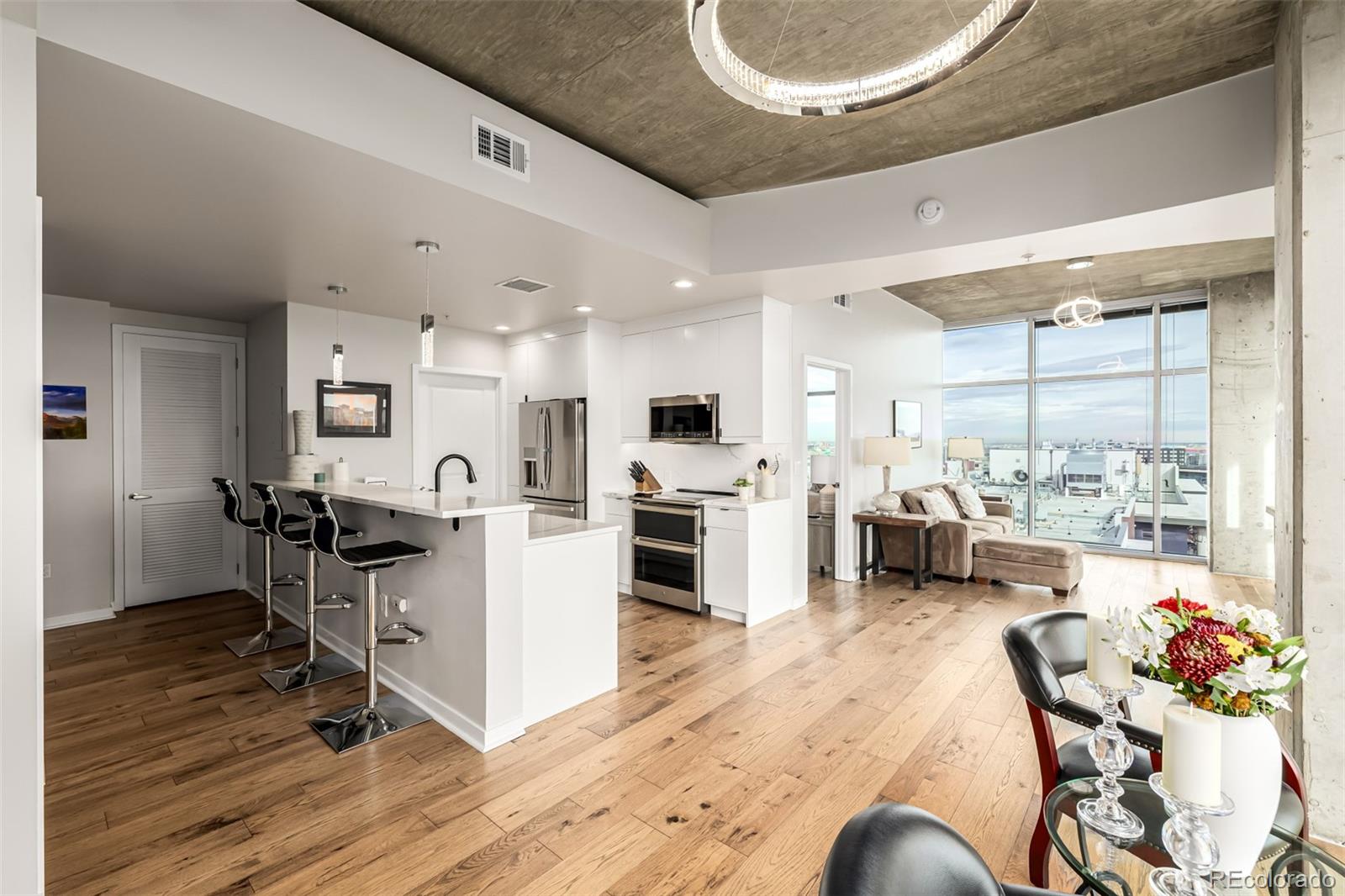 1700 Bassett Street, Unit 1412 Denver, CO 80202 - Photo 2 of 43 a living room with stainless steel appliances kitchen island granite countertop furniture and a view of kitchen