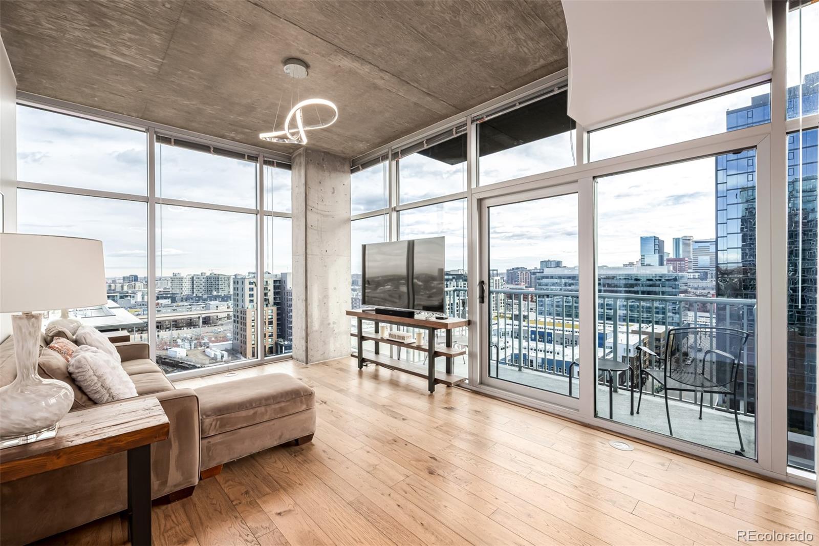 1700 Bassett Street, Unit 1412 Denver, CO 80202 - Photo 5 of 43 a living room with furniture and a floor to ceiling window