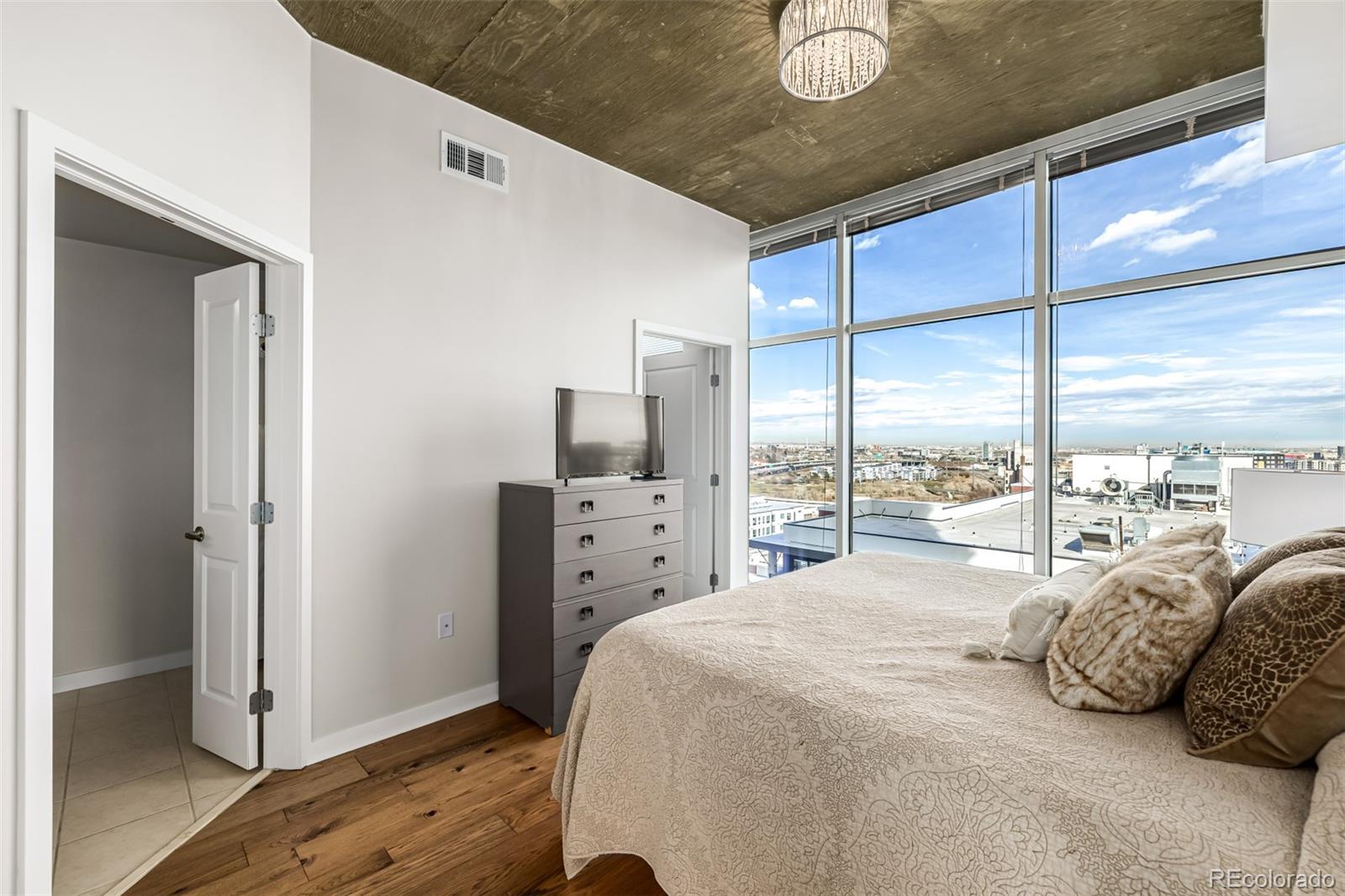 1700 Bassett Street, Unit 1412 Denver, CO 80202 - Photo 10 of 43 a bedroom with a bed and window