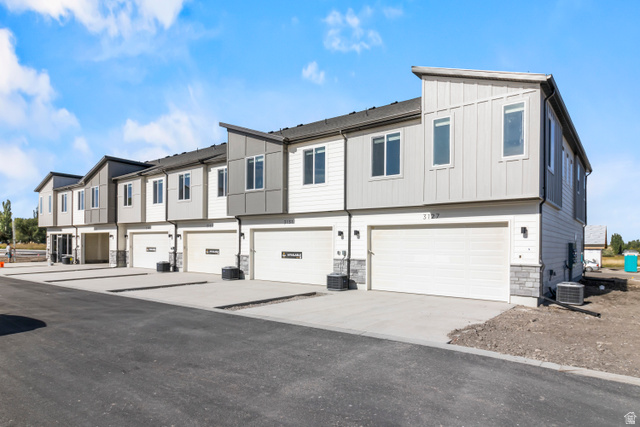 2995 South 265th Street West, Unit 752 Logan, UT 84321 - Photo 3 of 21 Contemporary townhome exteriors featuring multi-toned siding, stone accents, and sloped rooflines