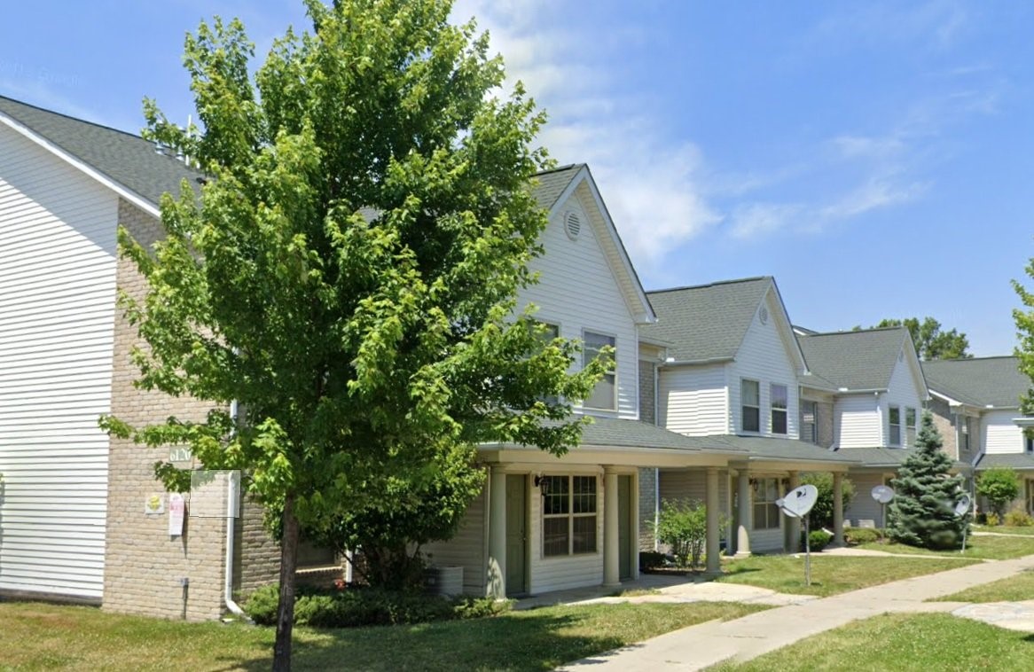 8931 Mt Elliot Street Detroit, MI 48211 - Photo 4 of 7 a front view of a house with a garden