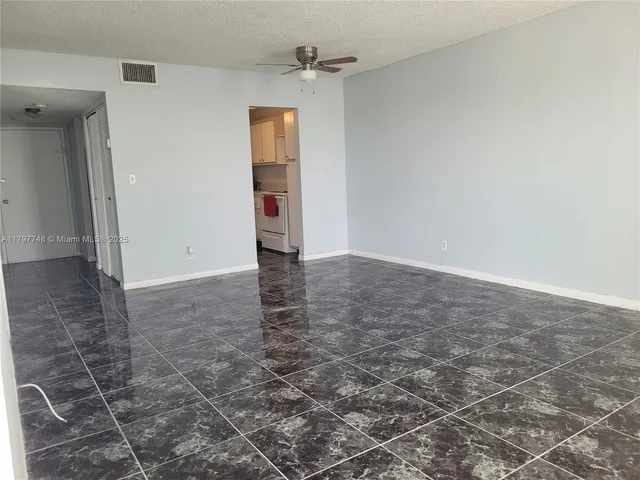 an empty room with windows and entrance