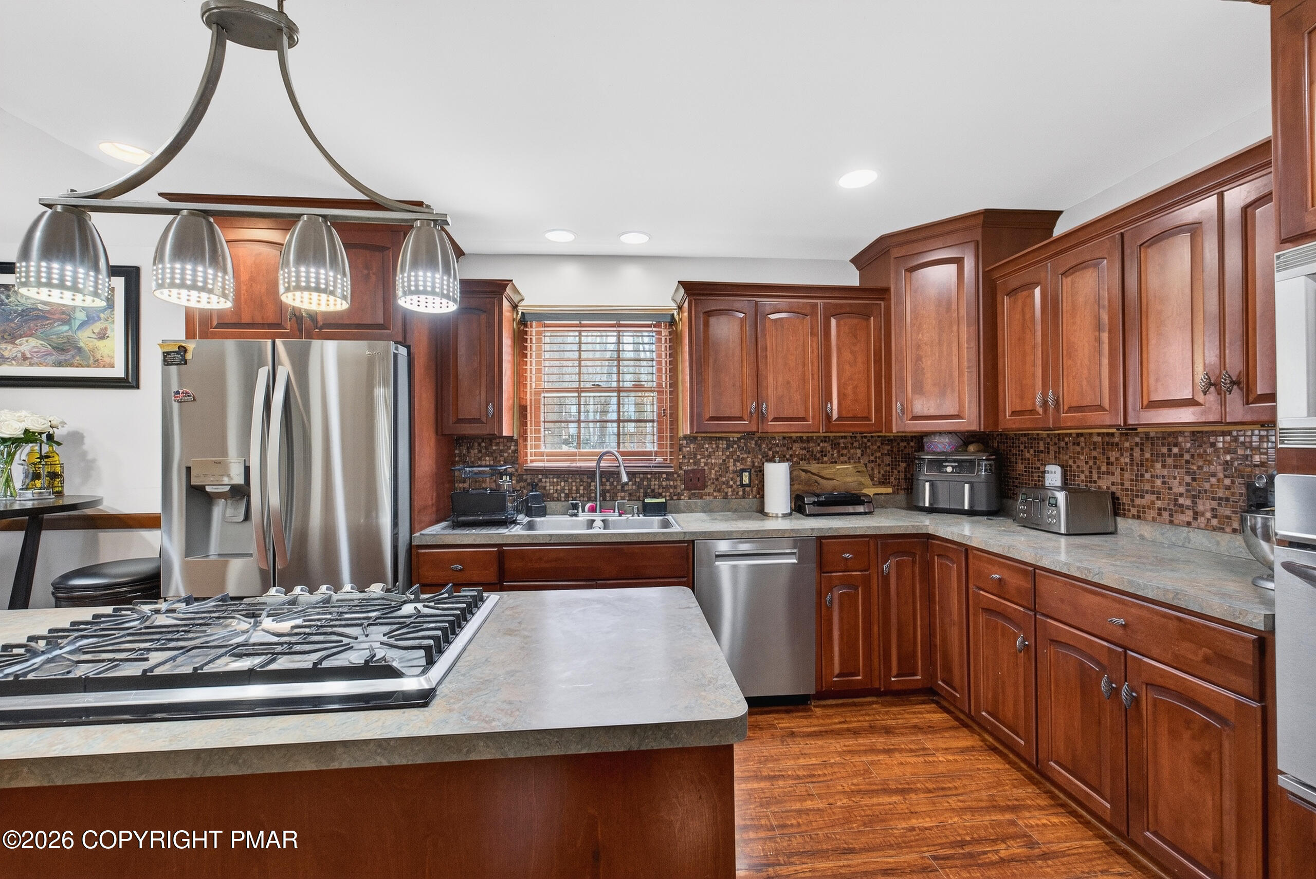 6293 Decker Road Bushkill, PA 18324 - Photo 18 of 38 a kitchen with stainless steel appliances granite countertop a stove a sink dishwasher and cabinets