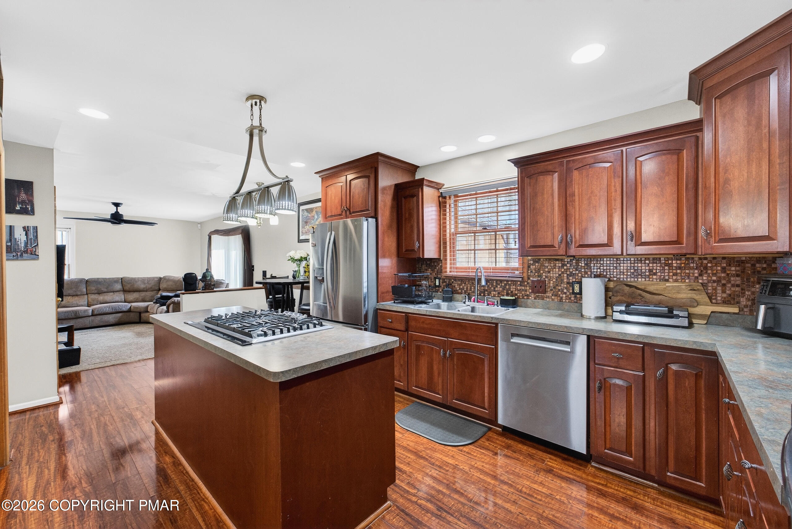6293 Decker Road Bushkill, PA 18324 - Photo 19 of 38 a kitchen with stainless steel appliances granite countertop a stove a sink dishwasher and a refrigerator with wooden floor