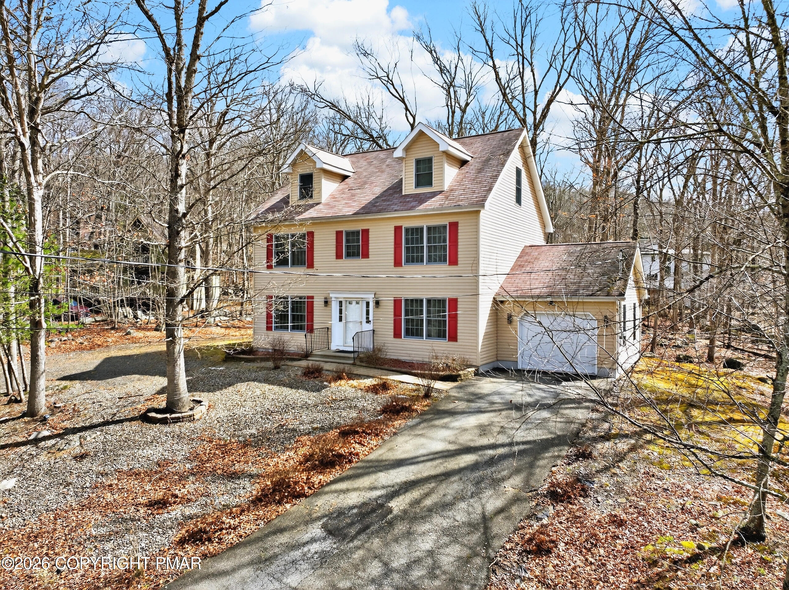6293 Decker Road Bushkill, PA 18324 - Photo 3 of 38 a view of a white house next to a road with large trees
