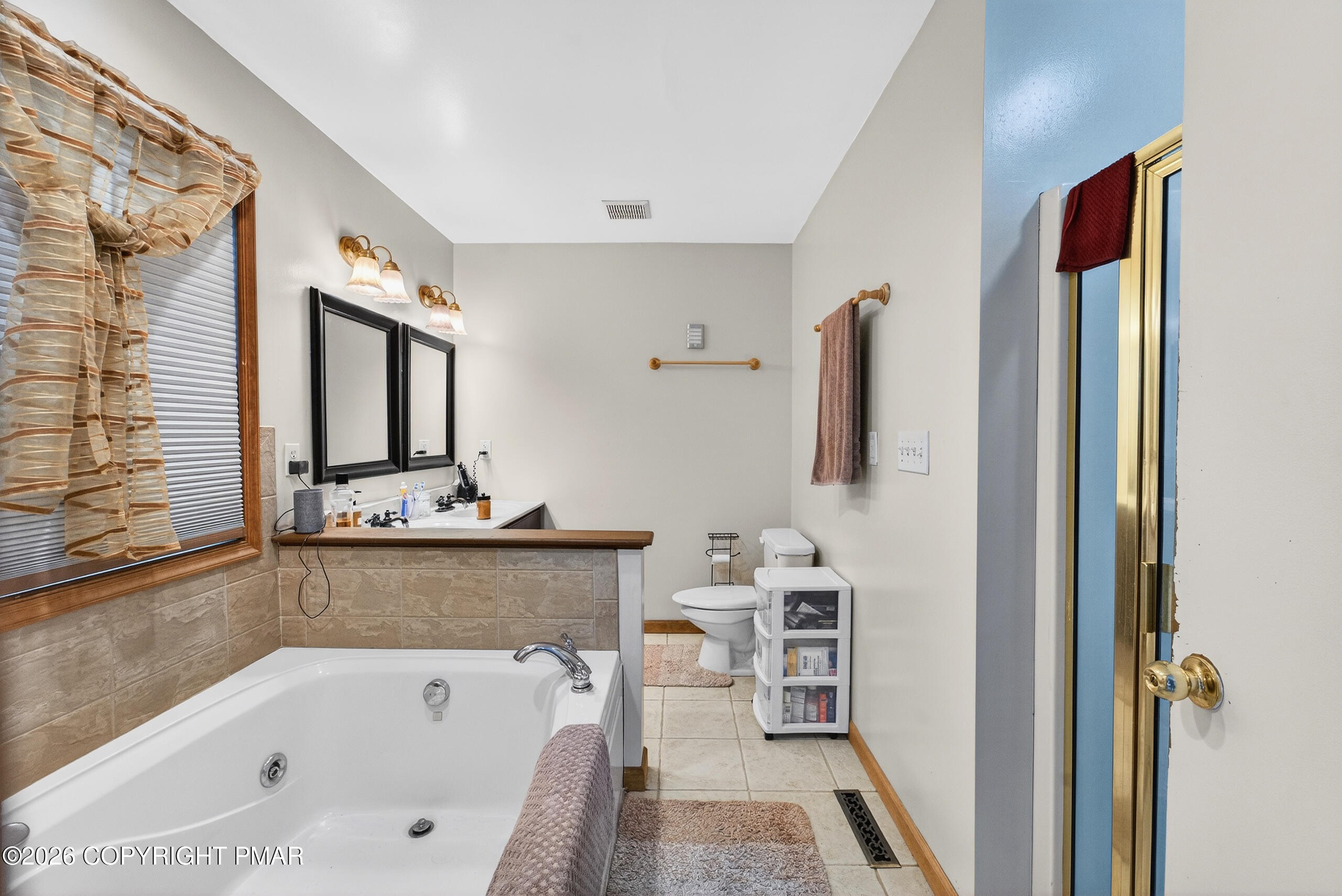 6293 Decker Road Bushkill, PA 18324 - Photo 31 of 38 a bathroom with a tub a sink and a large mirror