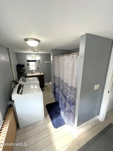 a bathroom with a toilet a sink and a shower