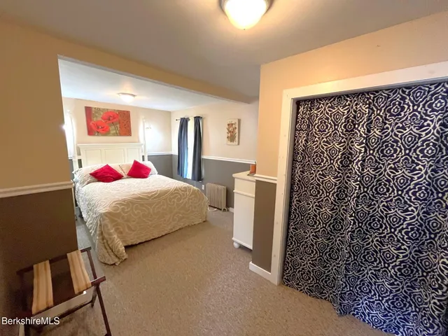 a bedroom with a bed and a desk