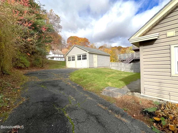 a view of house with yard and a garage