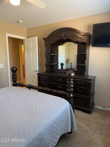 a bedroom with a bed and a television