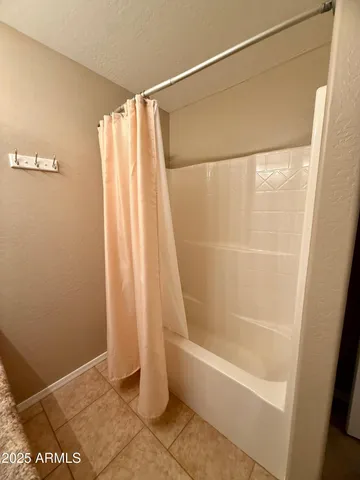 a bathroom with a shower and a bathtub