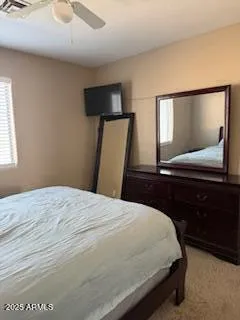 a bedroom with a bed and a mirror