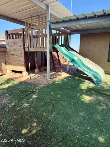 a view of a house with a yard and sitting area