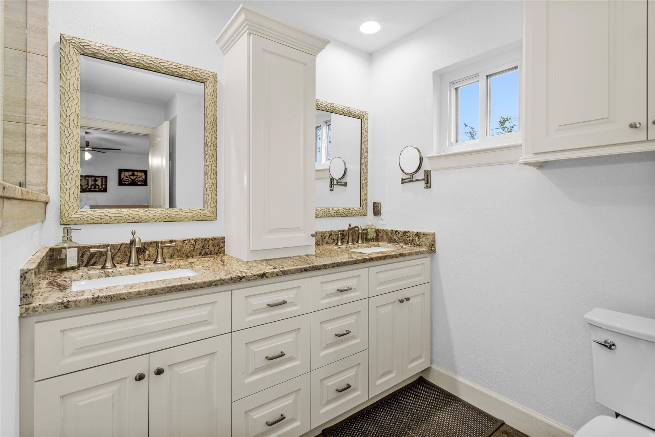 4402 Spears Road Manvel, TX 77578 - Photo 23 of 38 a bathroom with a granite countertop sink mirror and cabinets