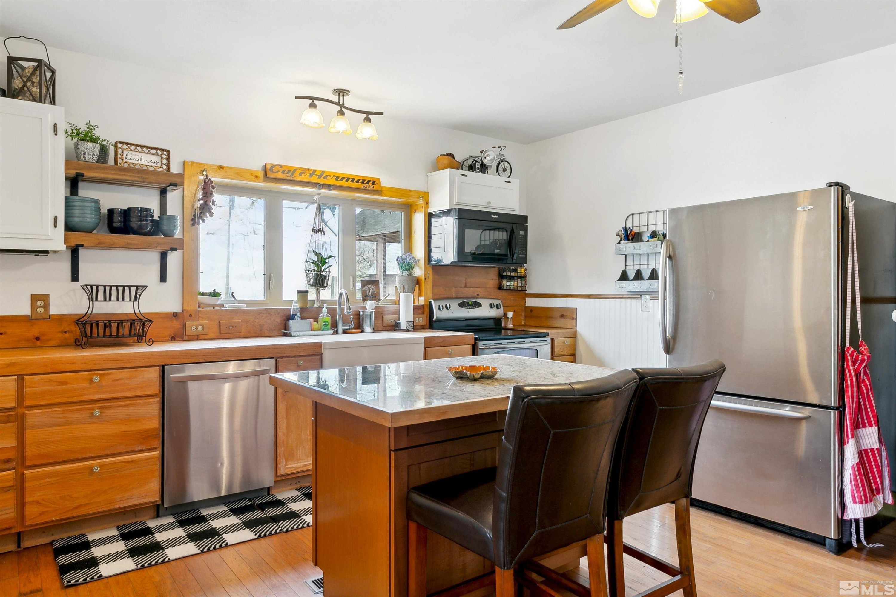 55 Main Street Dayton, NV 89403 - Photo 10 of 23 a kitchen with stainless steel appliances a stove a refrigerator and a sink