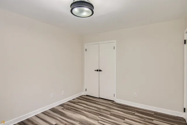 a view of a room with wooden floor