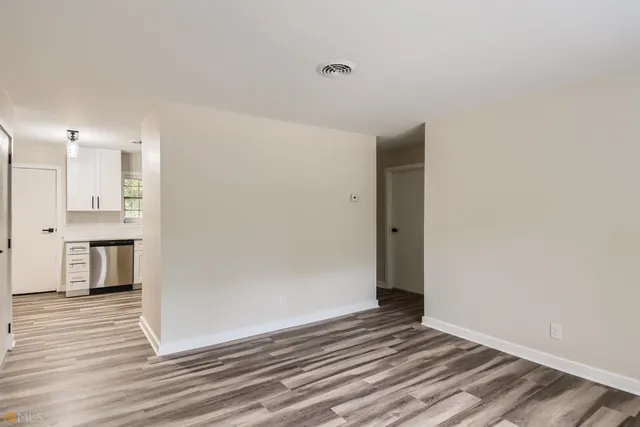 a view of a kitchen with wooden floor and a sink