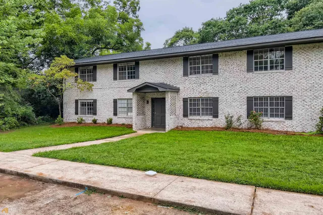 a front view of a house with a garden