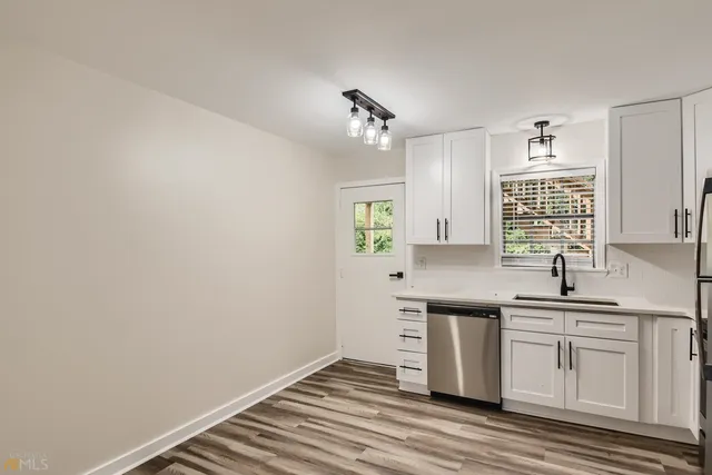 a kitchen with a sink cabinets and window
