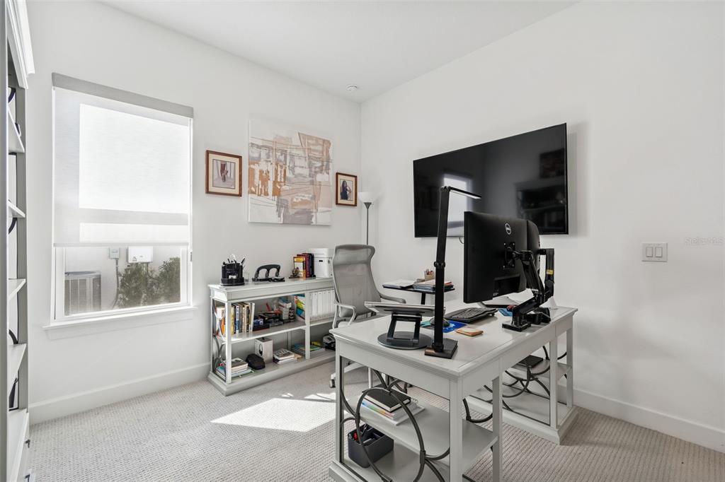 4848 Rosatti Road Wesley Chapel, FL 33543 - Photo 12 of 90 a living room with furniture a flat screen tv and a window