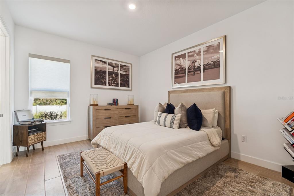 4848 Rosatti Road Wesley Chapel, FL 33543 - Photo 15 of 90 a bedroom with a bed and wooden floor