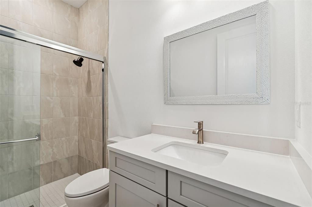 4848 Rosatti Road Wesley Chapel, FL 33543 - Photo 18 of 90 a bathroom with a sink a toilet and shower