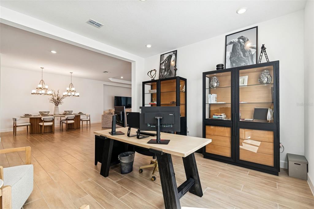4848 Rosatti Road Wesley Chapel, FL 33543 - Photo 22 of 90 a living room with furniture a flat screen tv and a floor to ceiling window