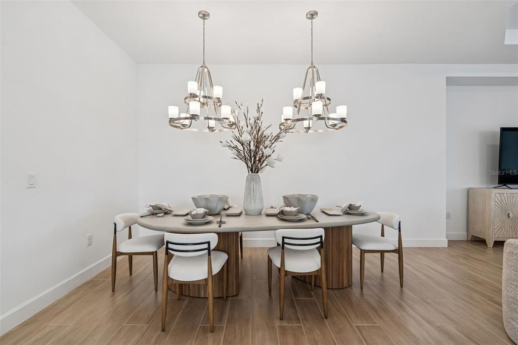 4848 Rosatti Road Wesley Chapel, FL 33543 - Photo 34 of 90 a dining room with furniture wooden floor a chandelier and a rug