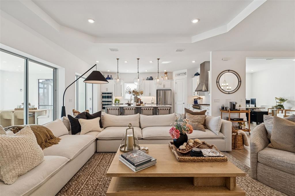 4848 Rosatti Road Wesley Chapel, FL 33543 - Photo 37 of 90 a living room with furniture a clock and a view of kitchen