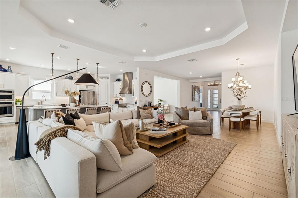 4848 Rosatti Road Wesley Chapel, FL 33543 - Photo 38 of 90 a living room with lots of furniture and a chandelier