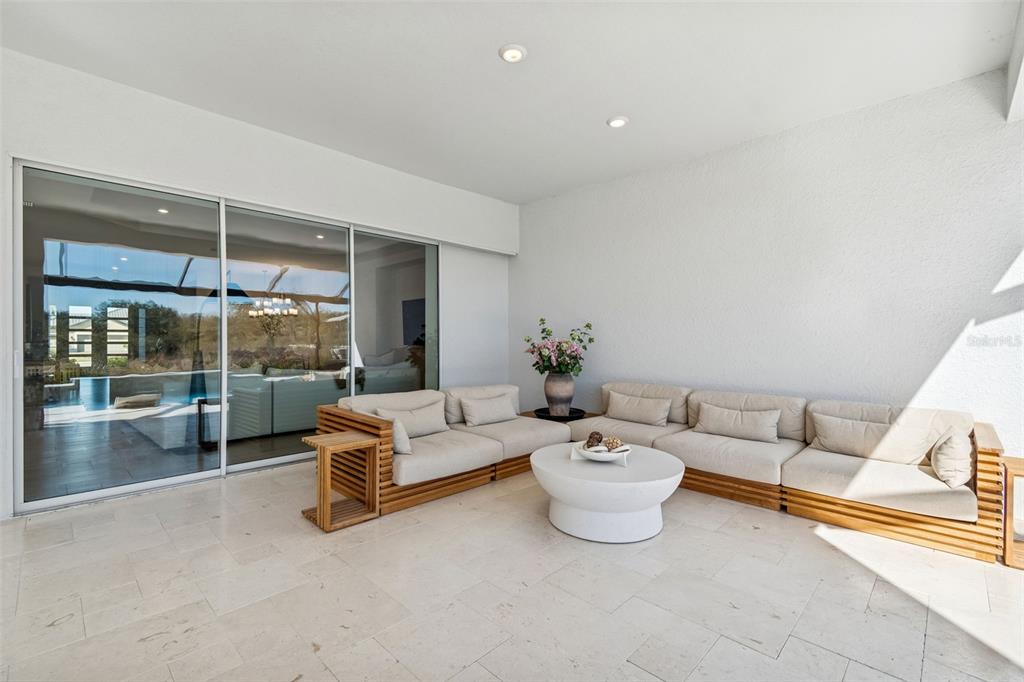 4848 Rosatti Road Wesley Chapel, FL 33543 - Photo 51 of 90 a living room with furniture and a floor to ceiling window