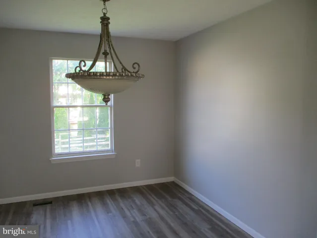 a view of room with window and wooden floor