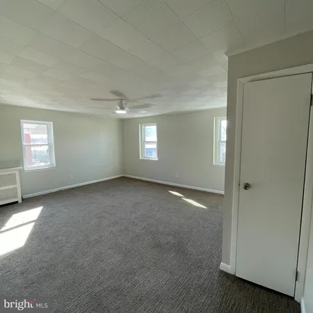 an empty room with windows and closet