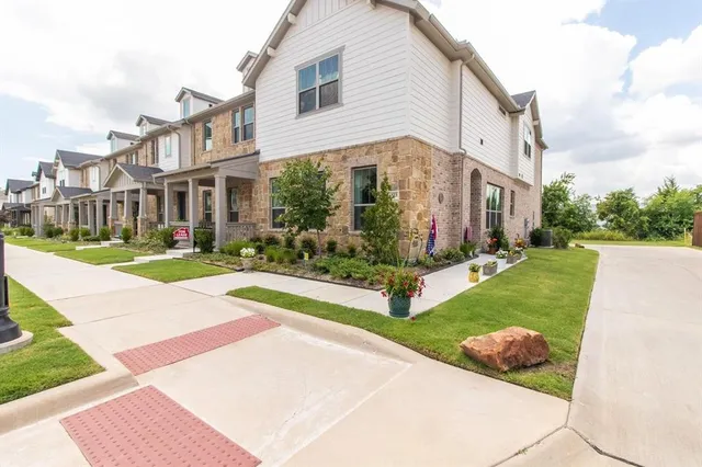 a city view with tall buildings and a yard