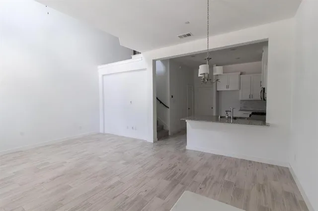 a view of a kitchen with a sink and refrigerator