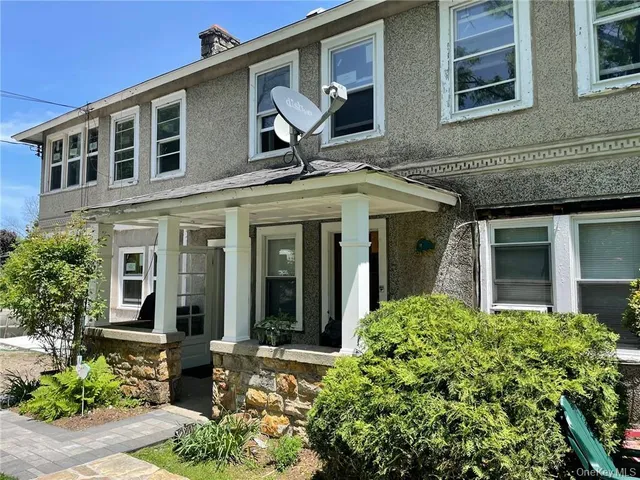 front view of a brick house with a large windows